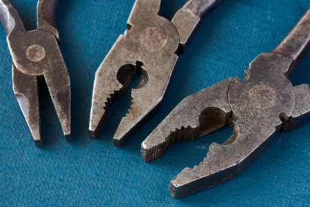Three old combination used pliers close-up, shallow depth of sharpnessの写真素材