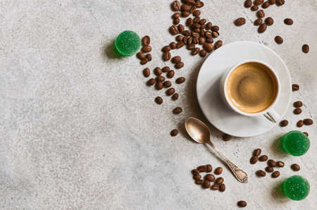 Espresso cup, fruit marmalade and fresh roasted coffee grains with copy spaceの写真素材