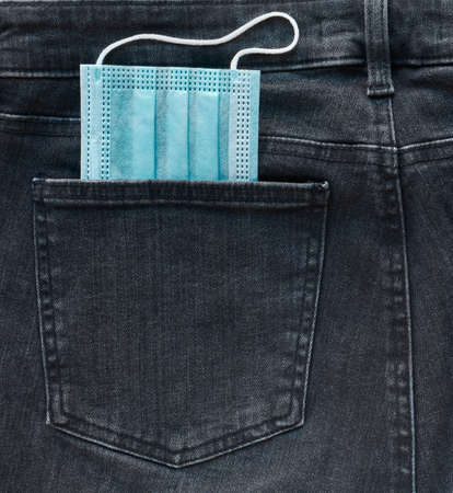 Medical mask in your jeans pocket, concept of carrying a protective mask with you every day,...