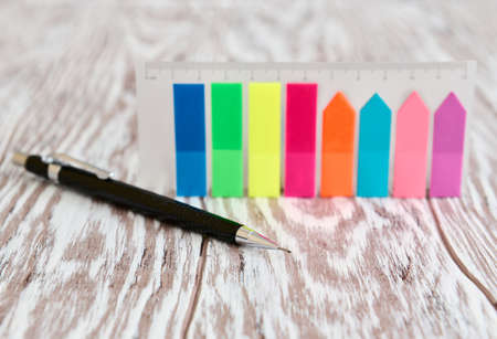 Automatic pencil and colored self-adhesive mark labels for notes, business concept