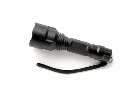Black modern LED pocket flashlight made of aluminum, close-up