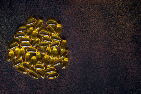 Fish oil capsules on table with space for text, omega 3, the concept of supporting immunity and healthの写真素材