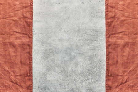Two folded linen napkins in the form of a frame on a gray background with space for textの写真素材