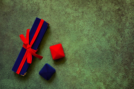 Luxury velvet jewelry gift boxes close-up on green background with space for textの写真素材