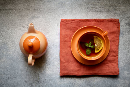 Tea ceremony, teapot and cup with tea on a linen napkin, stylizedの写真素材