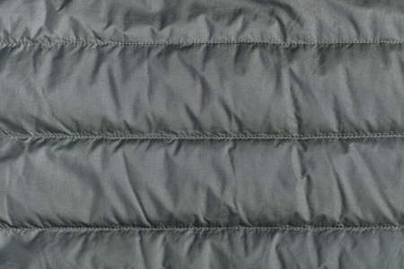 Textile background, green quilted polyamide down jacket textureの写真素材