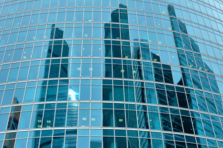Business center windows with the reflection of the nearby Moscow City skyscrapers: Moscow, Russia -...