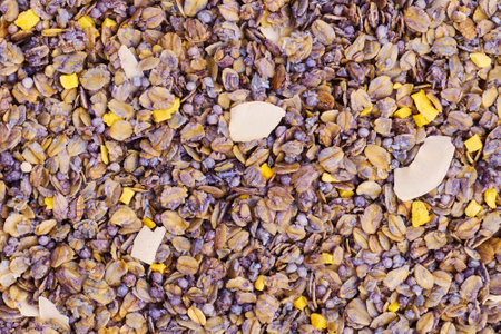 Background of dry breakfast with mango and passion fruit slices, macro