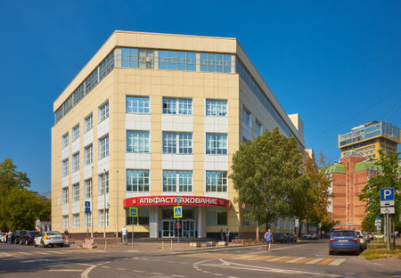 Modern corner office building at the intersection of Khavskaya Street and Konny Lane, inscription above the entrance Alpha insurance, cityscape: Moscow, Russia - August 26, 2022のeditorial素材