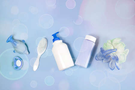 Bath products flat lay. top view of children's bathing things: shampoo, powder, comb, sponge, pacifier. Children's hygiene. Items For Newbornの写真素材