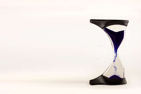 Time passing concept,urgency and running out of time. Sand fall in hourglass. Trend color classic...