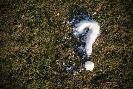 The question mark from the snow on the grass, close-up, copy spaceの写真素材