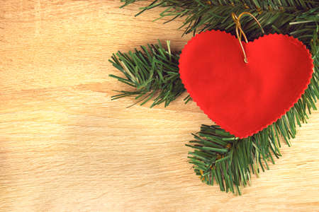 Background of the New year. Background with spruce branches and a Christmas toy in the form of a...