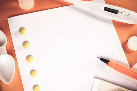 Treatment of colds and flu. Various medications, cold pills, throat spray, nasal drops, and a paper napkin on a white background. Treatment of influenza. Copy space.Medicine flat layの写真素材