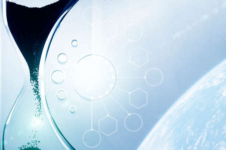 Time passing concept,urgency and running out of time. Sand fall in hourglass. Trend color classic blue. Color of 2020. Main trend of the year. Selective Focus. Copy space.の写真素材