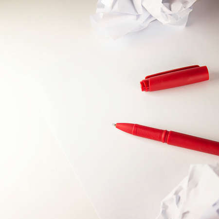 Blank sheet of paper and pen on on white background. Ballpoint pen lying on sheet of paper, copy spaceの写真素材