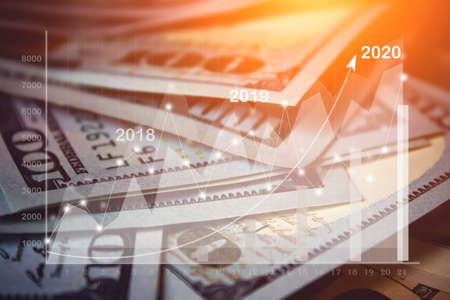 Close up perspective view of banknotes as background with virtual hologram statistics, graph. Money...