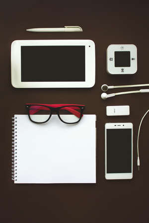 Set of different stationery, alarm clock and supplies on dark brown background. Back to school concept. Banner format. Top viewの写真素材