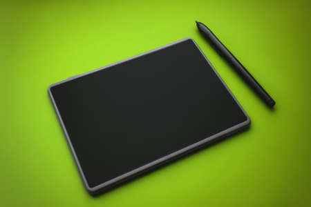 Graphic tablet pen on the surface of the device, close-up photo. graphic tablet with pen for illustrators and designers, on green backgroundの写真素材