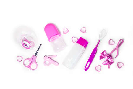 Children's hygiene: bath items, shampoo bottle, rubber toy, sponge, comb, thermometer, safety scissors top view, on a pink background. Children's personal care kit. Bath accessoriesの写真素材