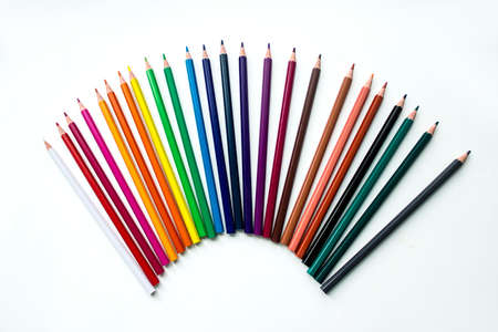 Colored pencils in row on white backgroundの写真素材