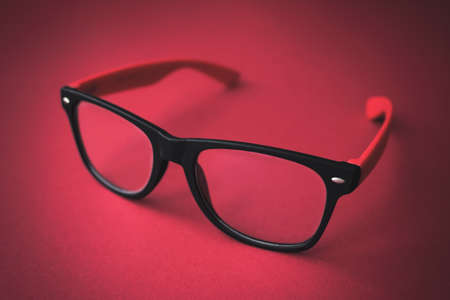 Beautiful Glasses on red background. Close-up. Eyecare conceptの写真素材