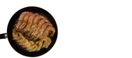 Tiger prawns are being cooked in oil on a frying panの写真素材