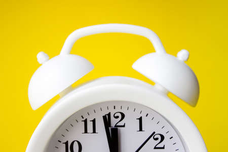 Close-Up Of Alarm Clock Over Yellow Background. Time conceptの写真素材