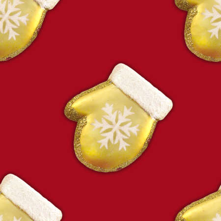 Seamless pattern of Gold Christmas Mitten With White Snowflake on red backgroundの写真素材