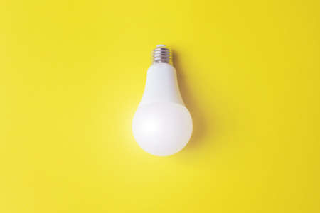 White glowing light bulb Against Yellow Background. Idea, creativity concept. Power energy economy...