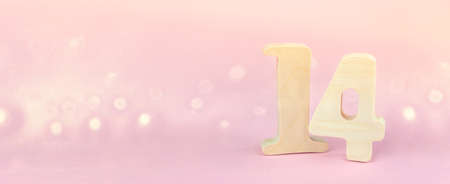 Calendar with 14 February date on pink background. Valentines day concept. Bokeh golden background. Copy spaceの写真素材