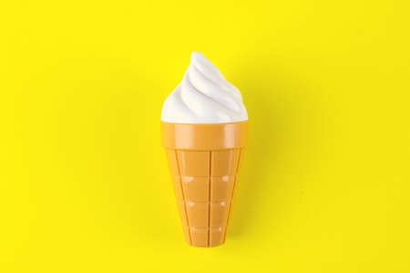 Toy ice cream on yellow background. Concept of harmful artificial food.Fast foodの写真素材