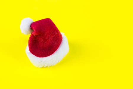 Red Santa's Christmas hat on yellow background