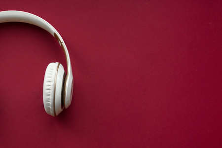 White Headphone With Red Background. Headphones for music soundの写真素材