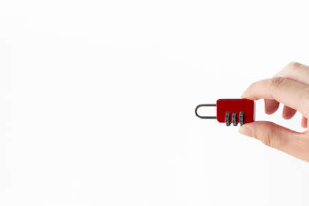 Combination red lock in hand on white background. Security Concept.の写真素材