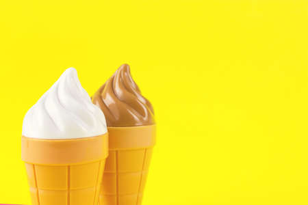 Ice cream toys made from plastic on yellow backgroundの写真素材