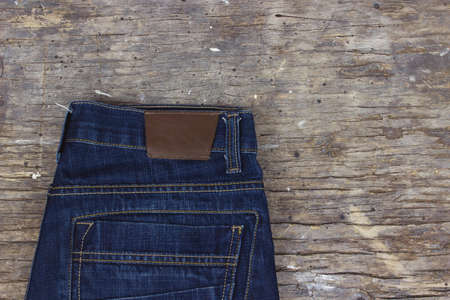 Blue jeans on old wooden table. Space for text.の写真素材
