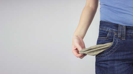 Close up Young Adult Woman in jeans showing empty pocket