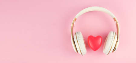 Headphones with red heart sign on pink backgroundの写真素材