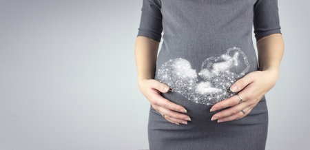 Pregnant woman touching her belly with hologram fetus. Mother anticipation Pregnancy, maternity...