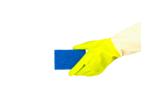 Spring cleaning concept. Top view of hand in yellow rubber gloves holding blue sponge on white...