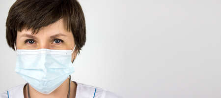The concept of medicine and health insurance. Close up portrait of confident doctor on white background. Confident female doctor at office desk.の写真素材