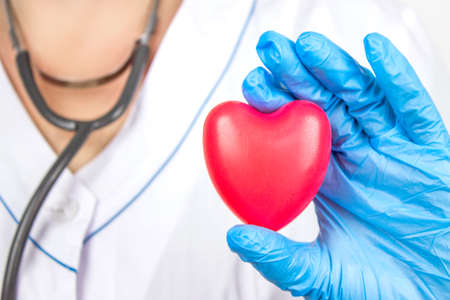 Ambulance. Cardiology Healthcare. Close up doctor hand holding a red heart at hospital office. Health care and patient, Failure and Diseases conceptの写真素材