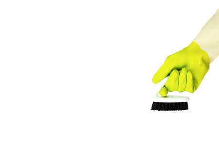 Spring cleaning concept. Yellow cleaning glove with a brush isolated on white. The concept of cleaning serviceの写真素材