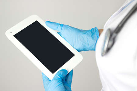 The concept of medicine and health insurance. Healthcare and technology. Doctor using digital tablet...