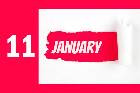 January 11st. Day 11 of month, Calendar date. Red Hole in the white paper with torn sides with calendar date. Winter month, day of the year conceptの写真素材