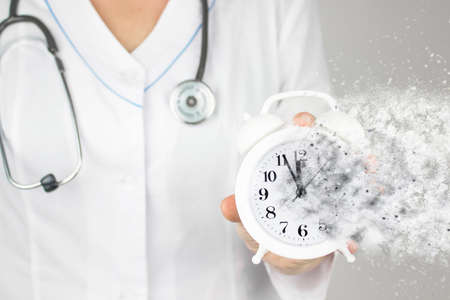 Time is crucial life saver. Concept healthcare. Doctor in white coat with stethoscope pointing and...