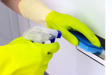 The concept of cleaning and disinfection. Disinfection and hygienic care using alcohol spray on the...