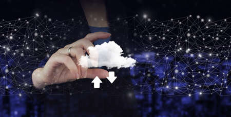 Download Data Storage Business Technology Network Concept. Hand hold digital hologram cloud, download, data sign on city dark blurred backgroundの写真素材