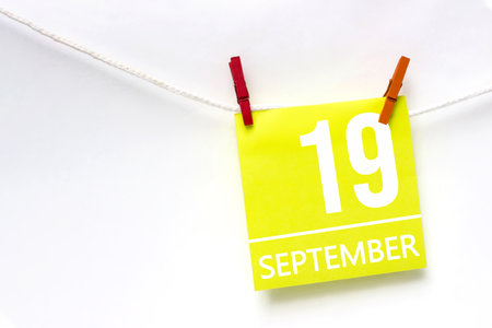 September 19th. Day 19 of month, Calendar date. Paper cards with calendar day hanging rope with clothespins on white background. Autumn month, day of the year conceptの写真素材